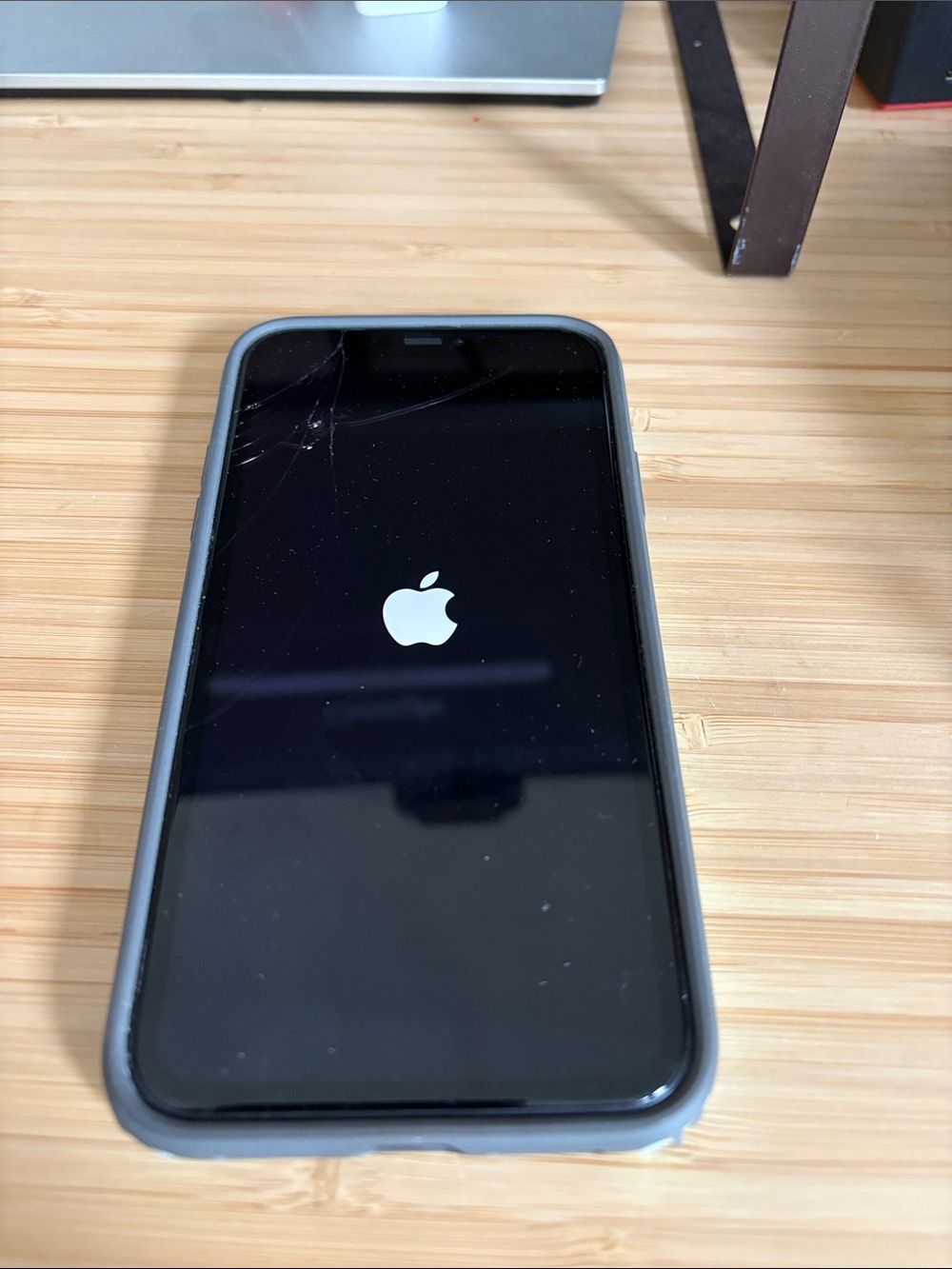 Apple iPhone with Gray Protective Case and Black Front
